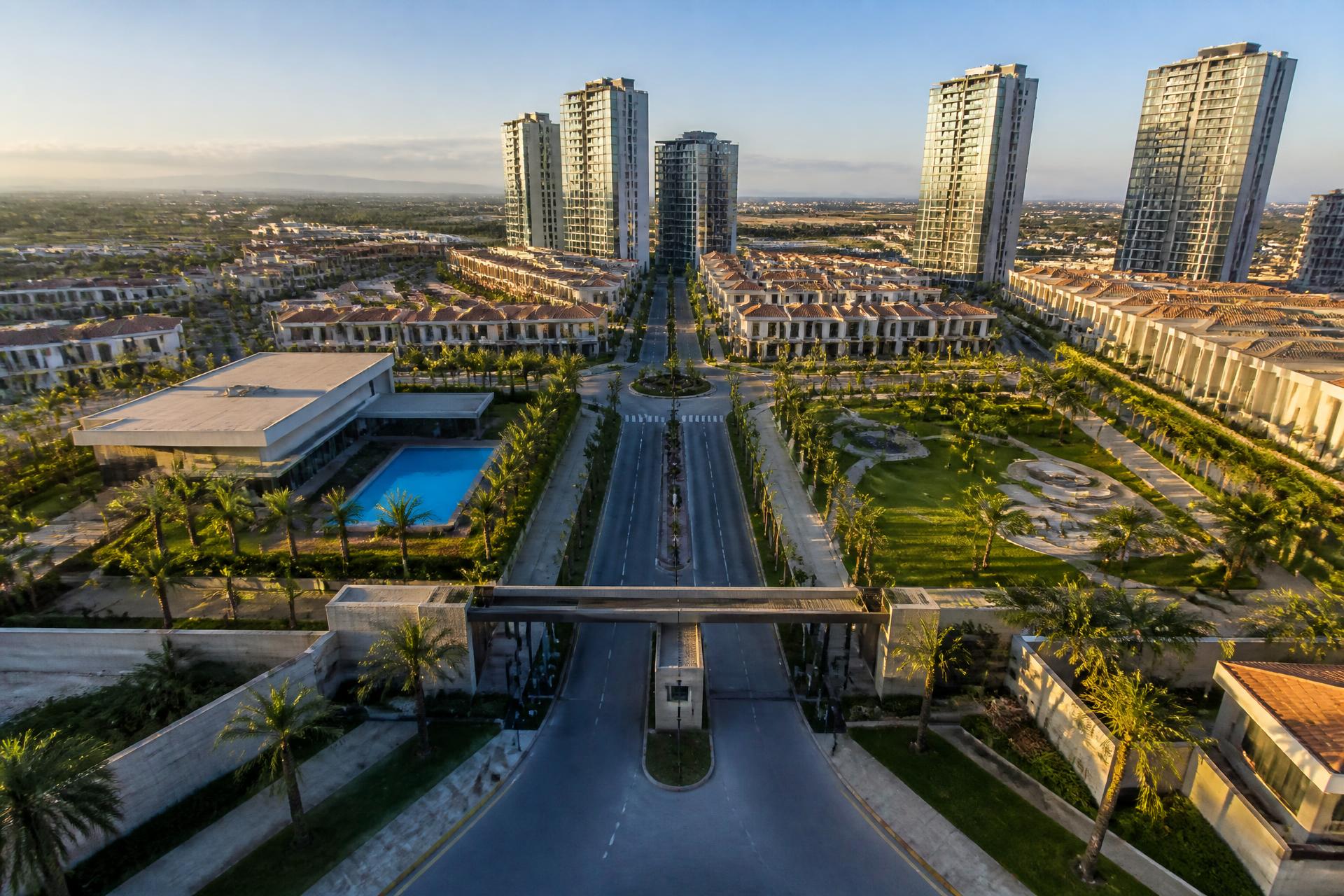 Aerial view of the developed CITYSCAPE gated community with boulevards, condo ridge houses and high-rise apartments